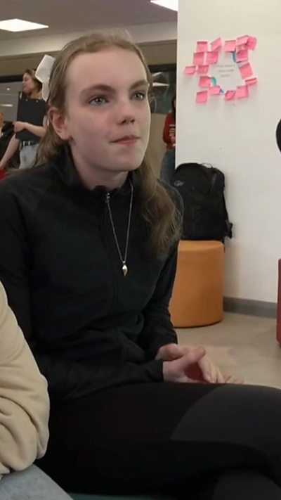 Young girl speaking to BBC in school