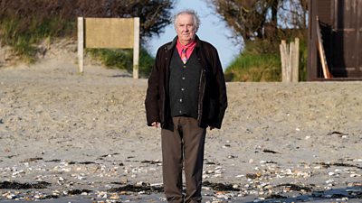 A man stands on a beach