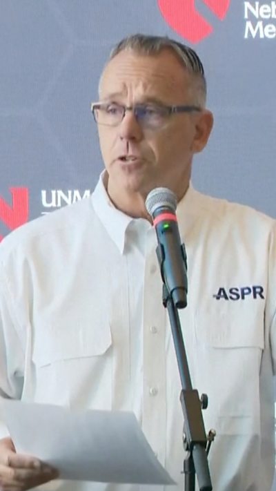 John Knox is seen talking to reporters.
