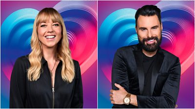 Left: A woman, Sara Cox, smiles to camera wearing a black zip up top. Right: A man in a black blazer and t-shirt smiles to camera. They're set against a background of a pink, purple and blue heart