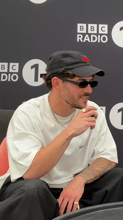 DJ Sorley in a white top, sun glasses and a hat.