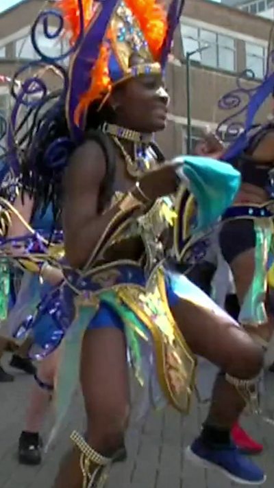 Woman dances in Luton Carnival parade
