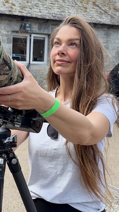 Springwatch presenter, Hannah Stitfall, uses a long lens to film nesting birds