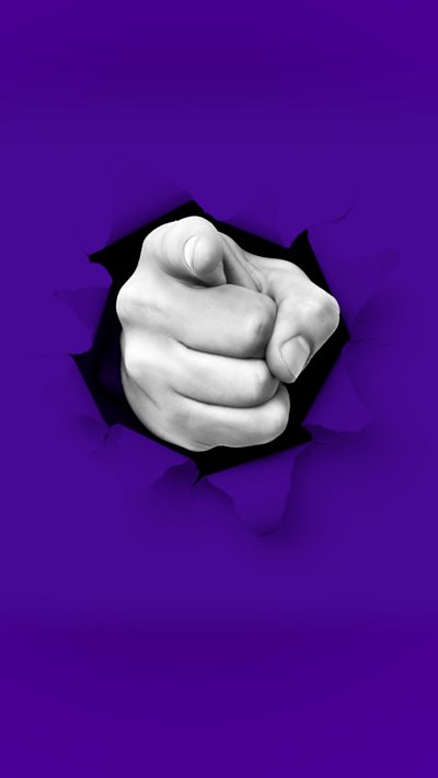 A hand rips through the screen, pointing at the camera