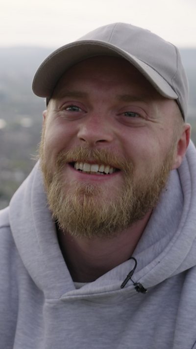 Conservationist, Aaron Kelly, smiles at the camera while talking