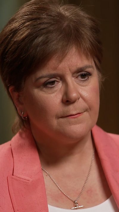Head and shoulder shot of Nicola Sturgeon. She is wearing a pink blazer and looking to the side.