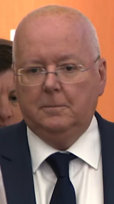 Balding man in suit with glasses