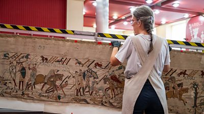A restorer working on transporting the bayeux tapestry