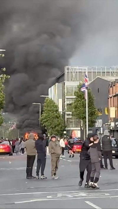 Smoke seen rising in the street from fire.