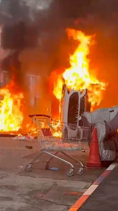 Car on its side on fire