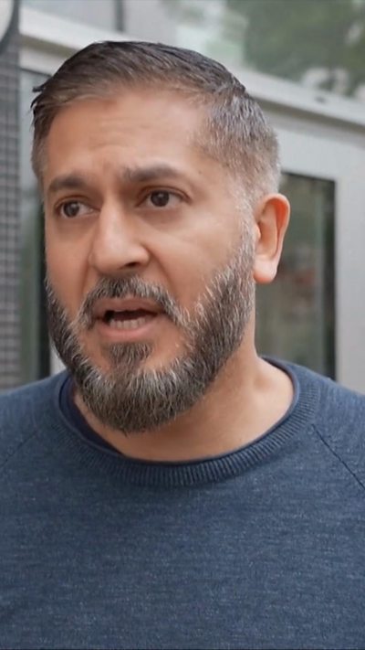 Akram speaking as he looks off camera