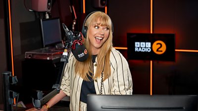 Sara Cox in the radio 2 studio smiling away from camera