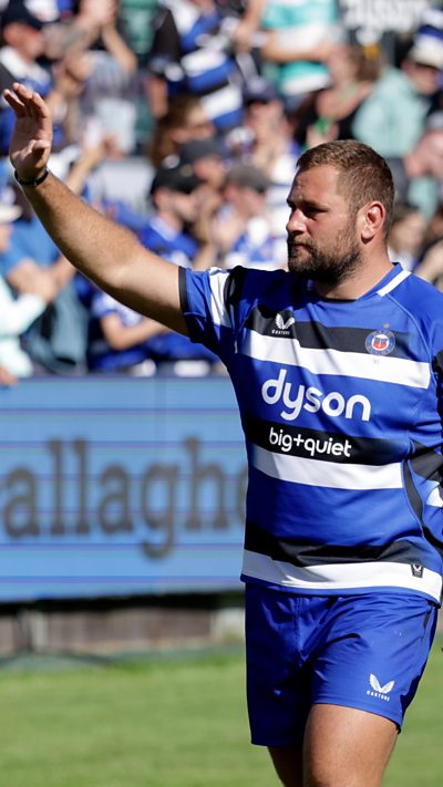 Thomas du Toit in blue Bath kit holding his arm in the air