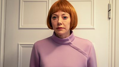 Diane Morgan with a red bob and a pink nurse uniform