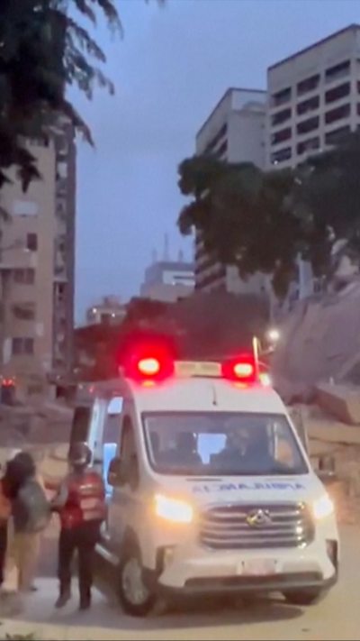 Ambulance and first responders on scene of collapsed building in Caracas Venezuela