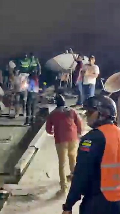 People searching through rubble of collapsed building