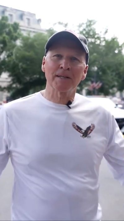 Man in baseball cap and white shirt