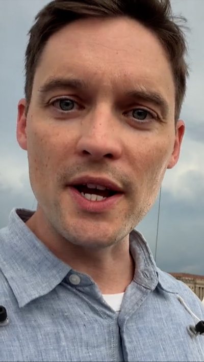 Man in light grey shirt