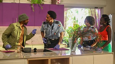 DI Mervin Wilson (Don Gilet) wears safari clothing with blue gloves and inspects a crime scene.