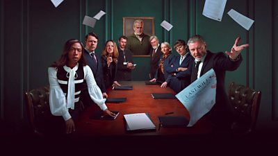A group of eight people stand around a long wooden table looking unhappy as they throw the papers of a will in the air. A portrait of a man hangs at the head of the table, looming over them.