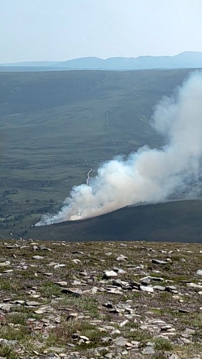 Large plume of smoke from a distance taken on top of a hill