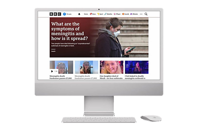 A computer shows the BBC News online website with an article on Meningitis visible.