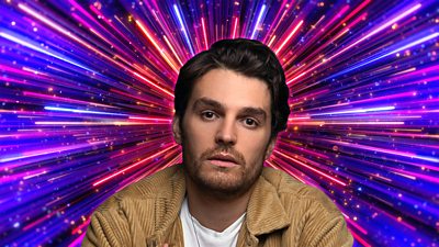 Headshot of Lawrence Robb in front of branding for Strictly Come Dancing 2026 - a background of glittering pink, purple and gold beams of light. 