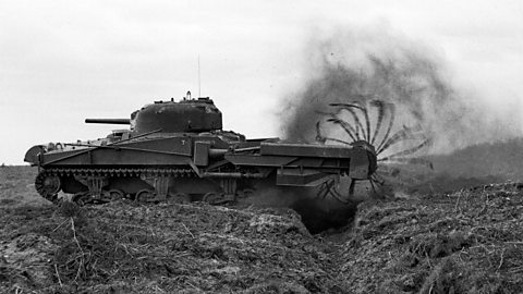 Photograph of a crab tank, fitted with a flail rotor to cut through barbed wire. 