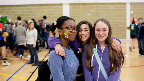 Three girls wearing their own clothes at school