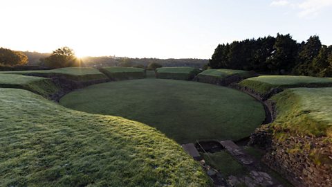 The Roman amphitheatre in Caerleon, which is covered by grass.