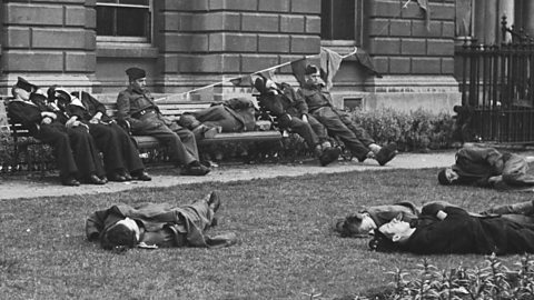 People slumped and lying down after VE day celebrations 