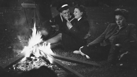 People celebrating around a fire