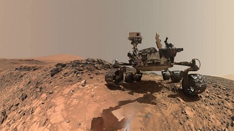 The Curiosity rover on the surface of Mars.