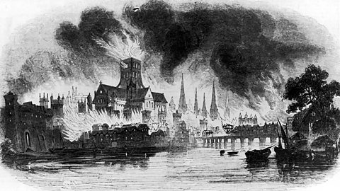 The original St Paul's Cathedral in flames, with the Tower of London in the background