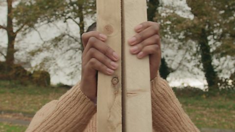 Female clacking two blocks of wood