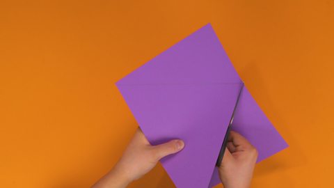 Someone cutting through a piece of card