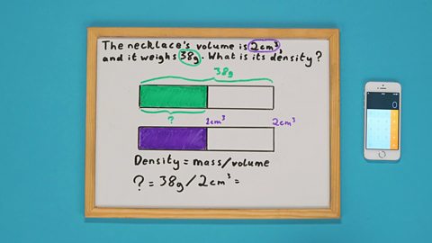 A whiteboard with two shaded bars drawn on it and a calculator on the side