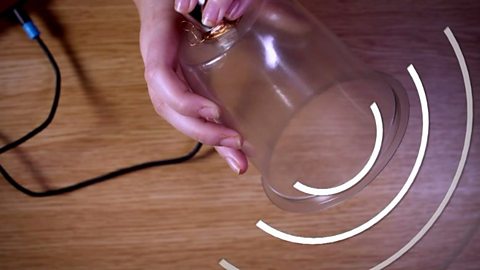 An image of the plastic cup producing sound waves