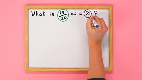 An image of a whiteboard with someone writing a maths problem on it