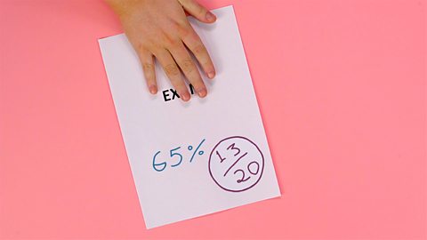 An image of an exam paper with the final percentage score written on it