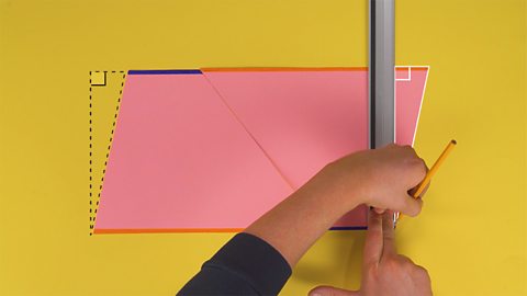 An image showing someone drawing a straight line with a ruler towards the end of the trapezium