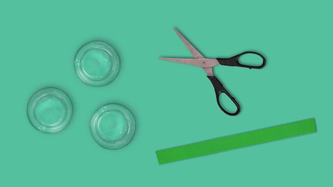 An image showing glasses, scissors and ribbon