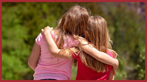 An image of two young girls arm in arm.