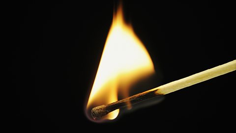 A close up of a burning match 