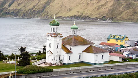 A white-coloured church with a green, domed steeple in Alaska (Credit: John Zada)