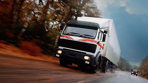 Articulated lorry on wet country road