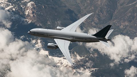 Birds eye view of aeroplane flying over mountains