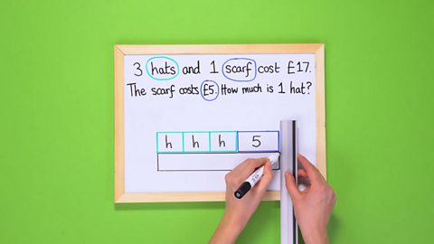 A maths problem with some bars being drawn on a mini whiteboard