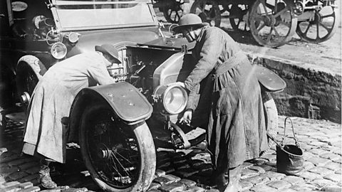 Women's Army Auxiliary Corps mechanics at work on a car engine in France