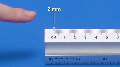 A 2 mm ball of modelling clay measured on a ruler.